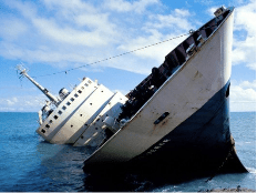 A ship partially submerged in water, leaning at an angle against a blue sky with scattered clouds.