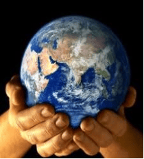 Hands holding a small globe representing Earth against a dark background.