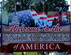 Welcome sign for the United States of America, featuring iconic symbols such as the Statue of Liberty, the Capitol Building, and mountains, with an American flag background.